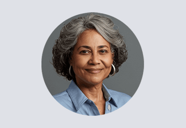 Head and shoulders photo of smiling female freelancer with gray hair wearing a light blue shirt