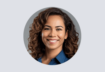 face of smiling female freelancer with brown curly hair and a blue shirt